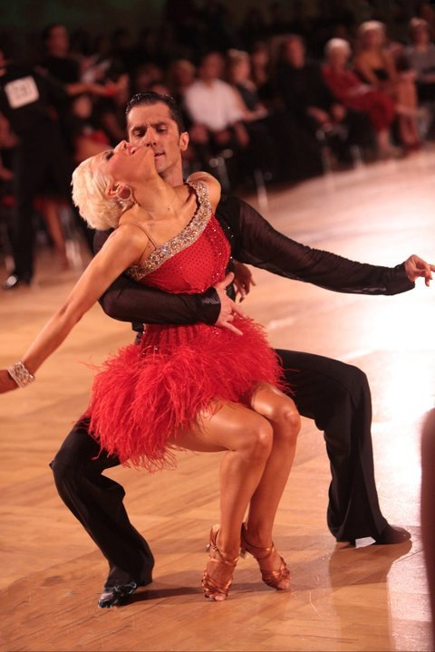 Decho and Bree performing American Rhythm in red feather costume