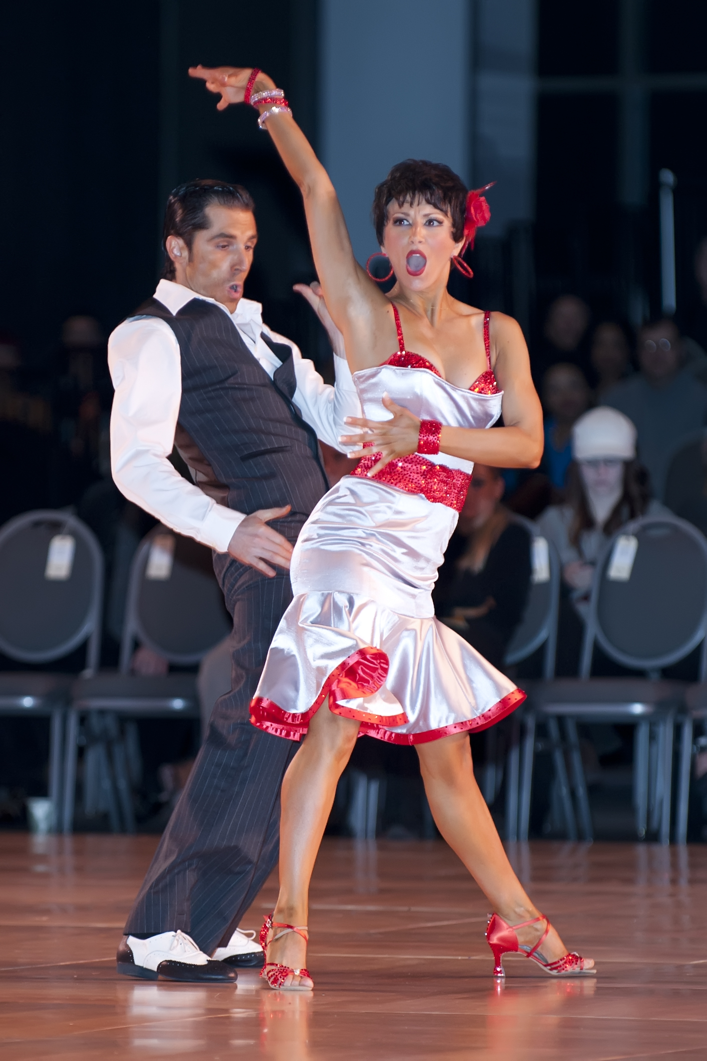 Decho and Bree in white and red ballroom performance costumes
